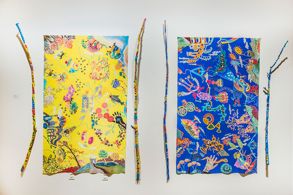 Silk Painting of Doodles displayed with Painted Sticks