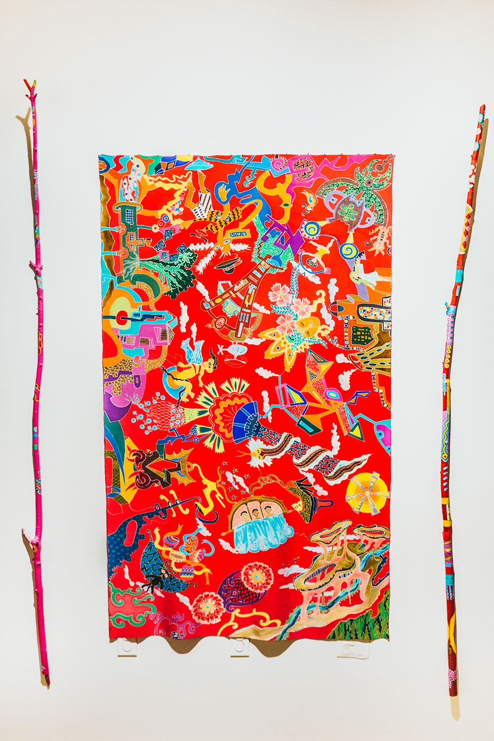 Silk Painting of Doodles displayed with Painted Sticks